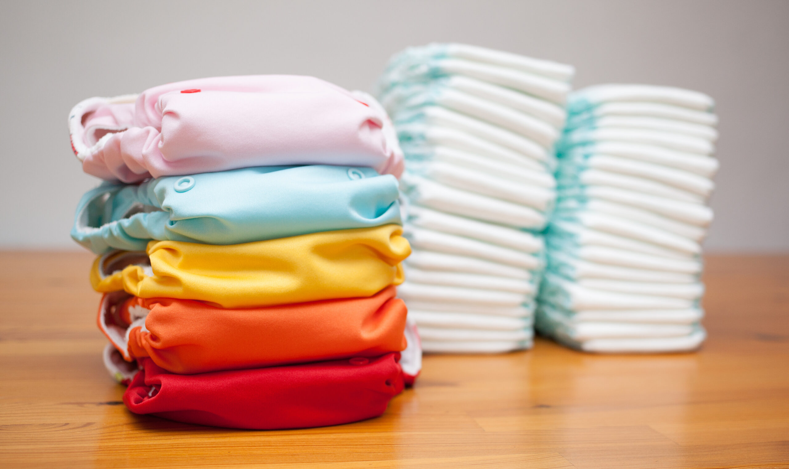 Stacks of disposable diapers and modern diapers together